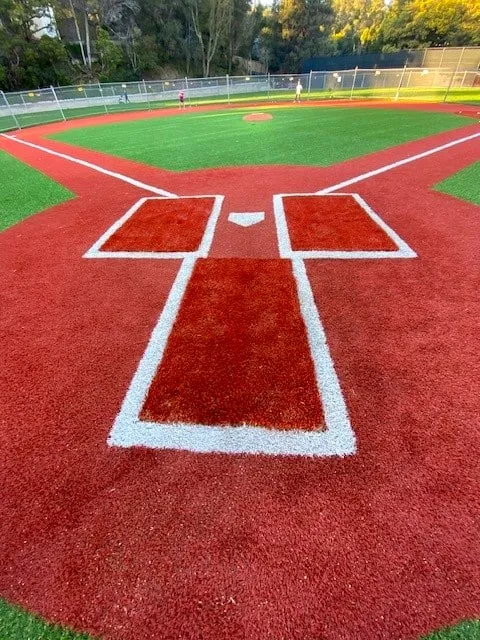 Finished red batter's boxes and catcher's box with white lines at home plate