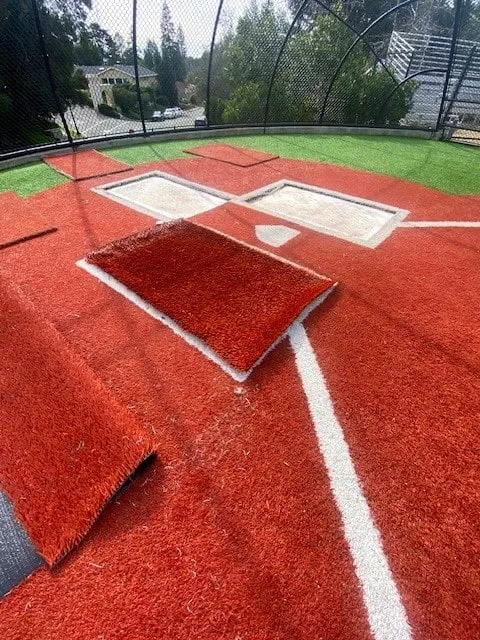 New red turf batter's box being laid over the old white box