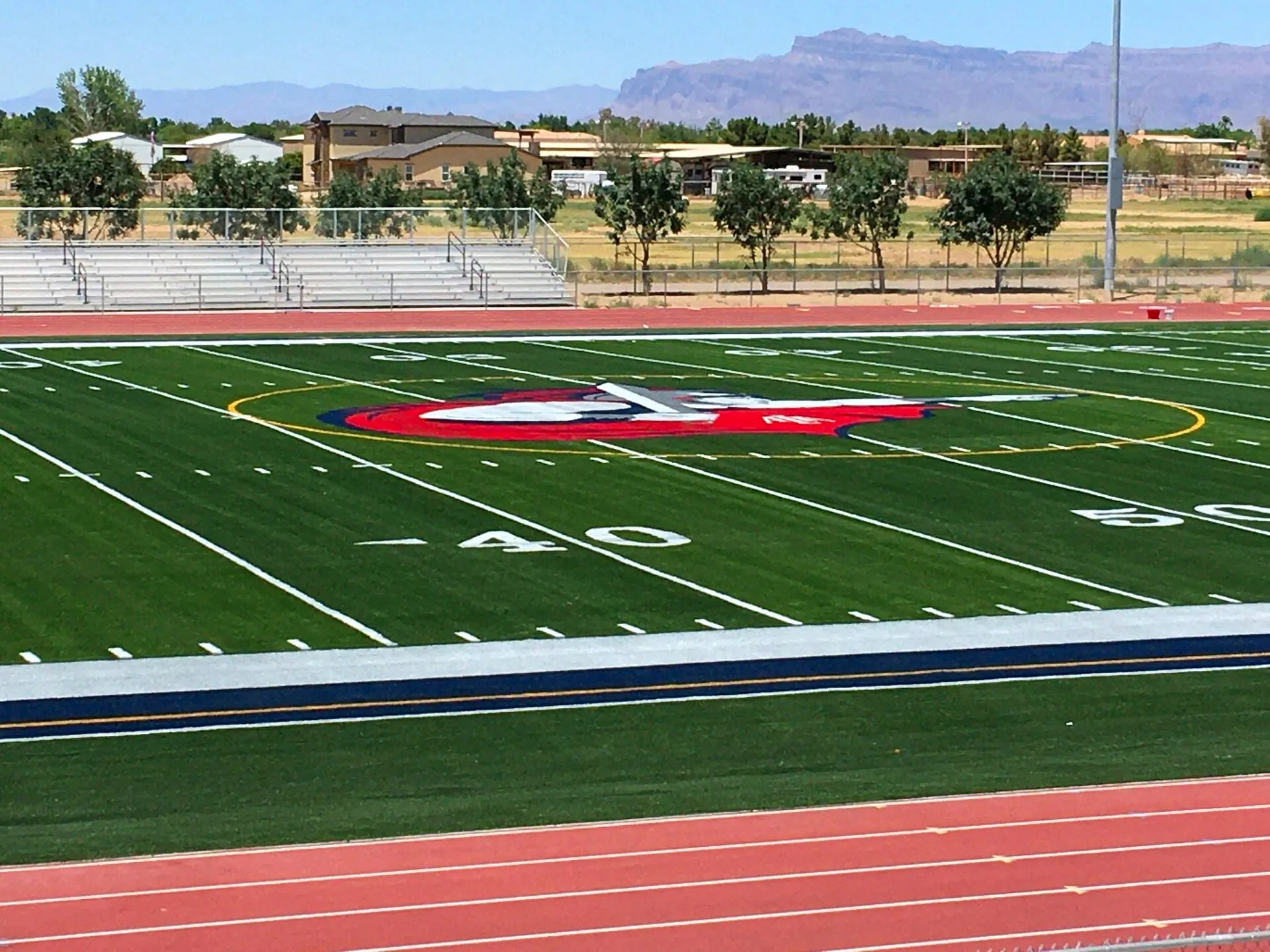 Synthetic turf football field with running track