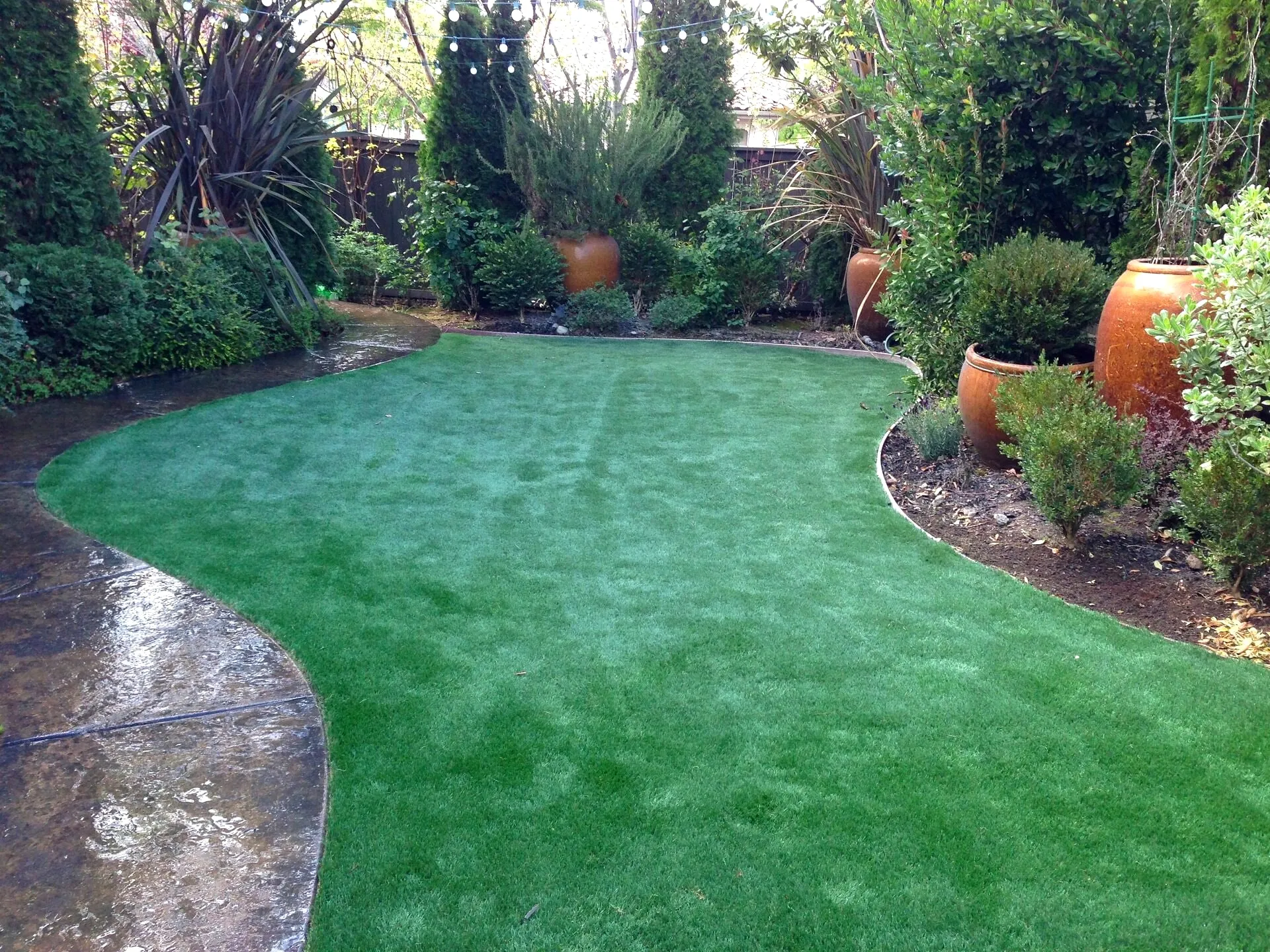 Synthetic lawn in a landscaped yard