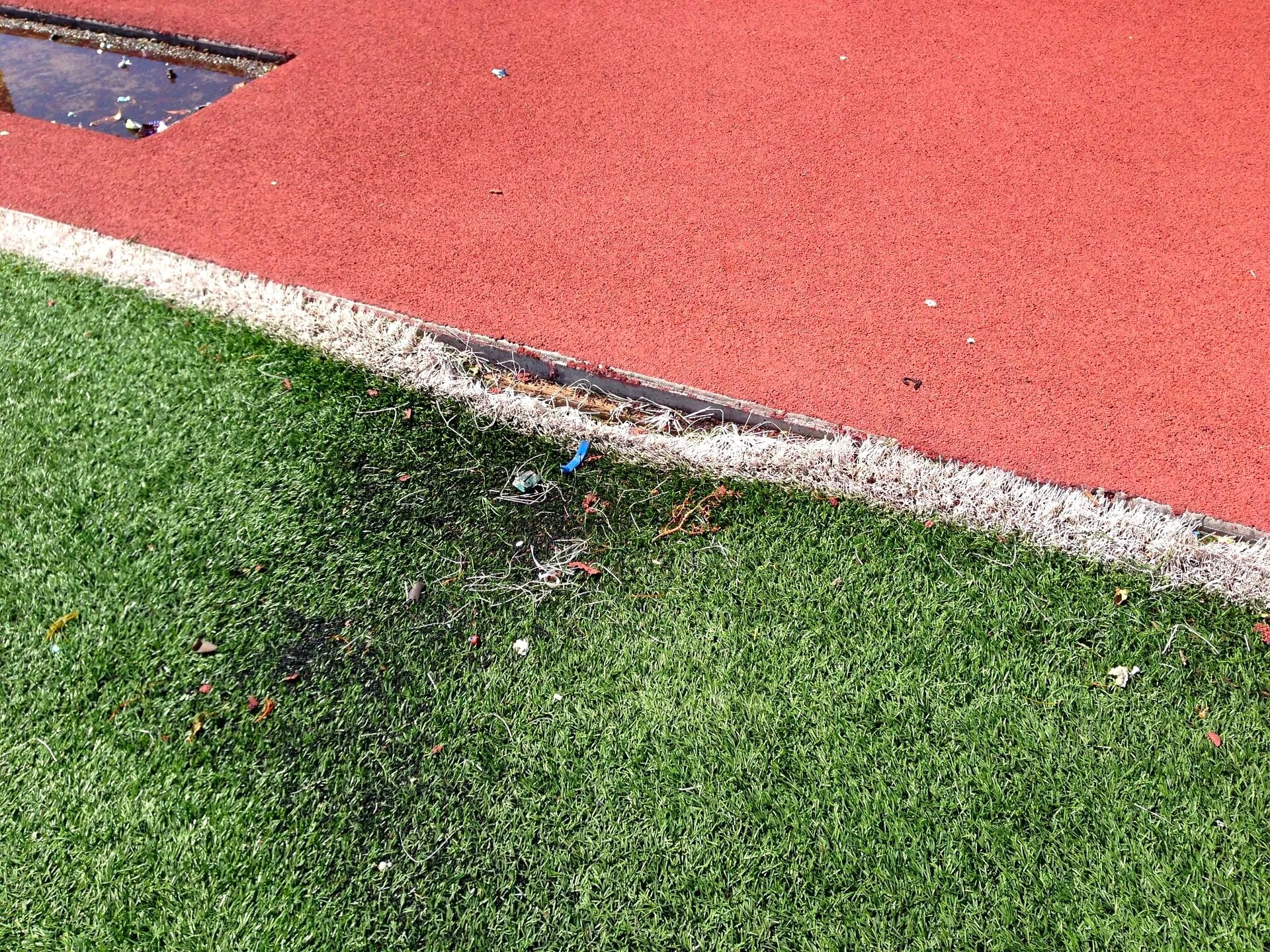 Synthetic turf edge meeting a running track